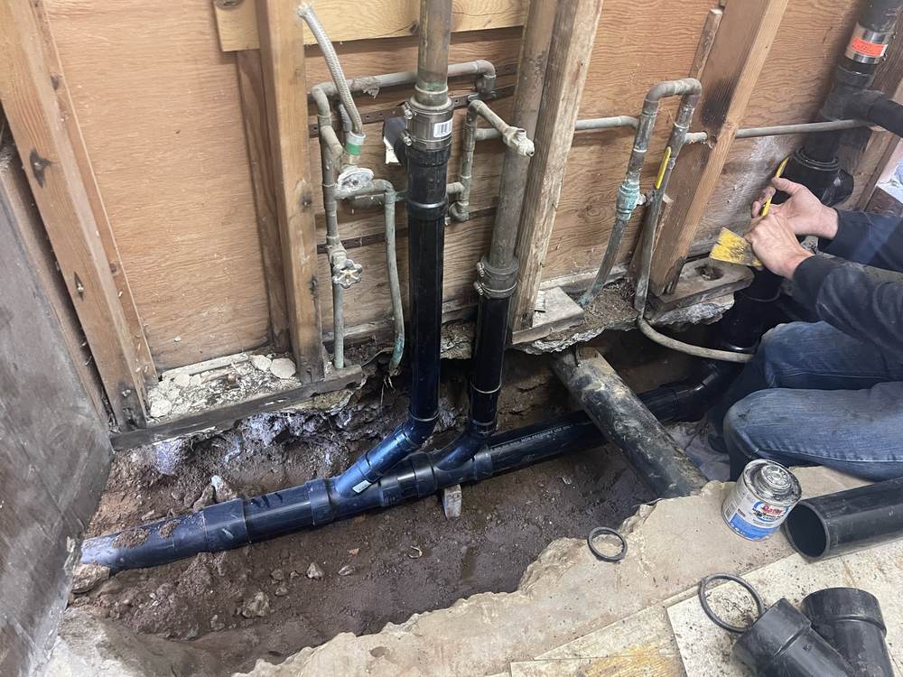 C3 plumber replacing under-slab drain lines during a repipe